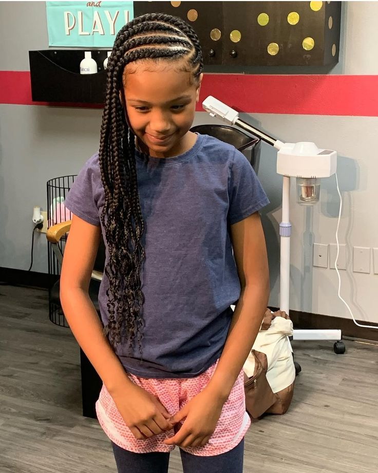 A young girl with a side swept staright cornrow