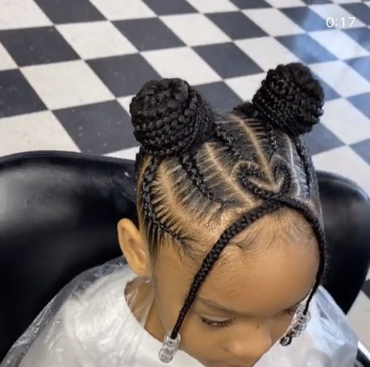 Young girl with a cornrow space bun
