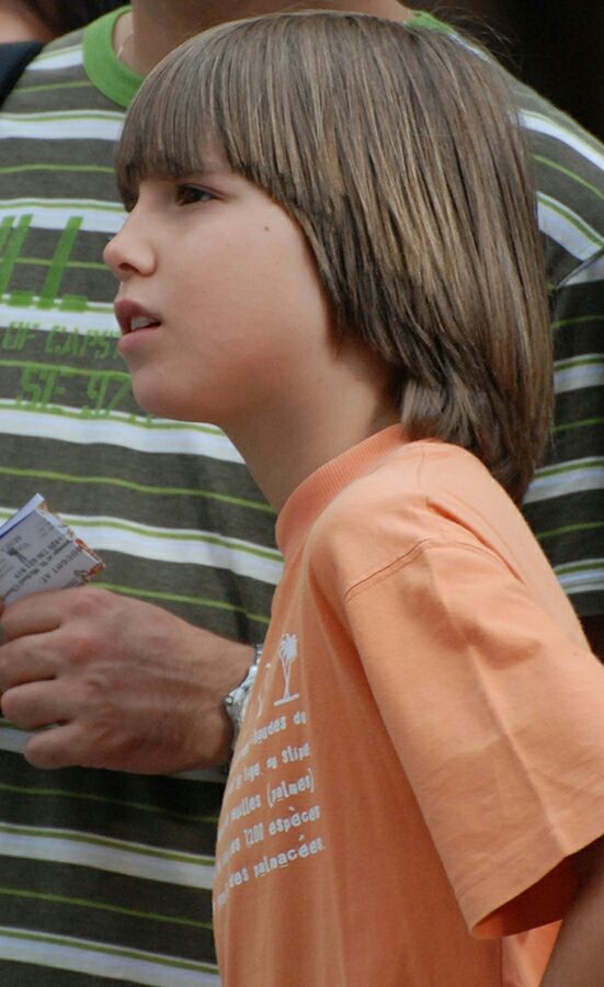 Boy with a shaggy bowl cut, rounded blunt fringe with longer layered ends falling past the ears.