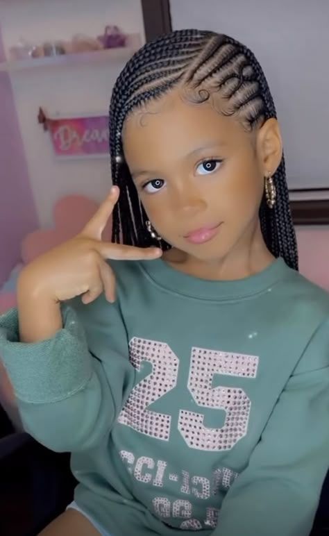 Little girl wearing feed in braids with a deep side part.