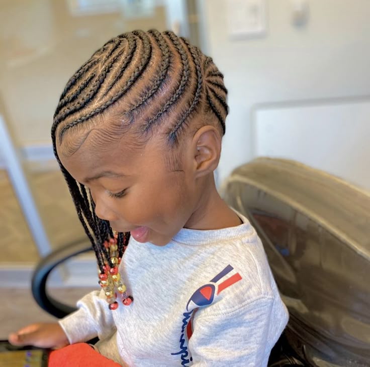 Side swept feed in braids styled neatly on a little girl.