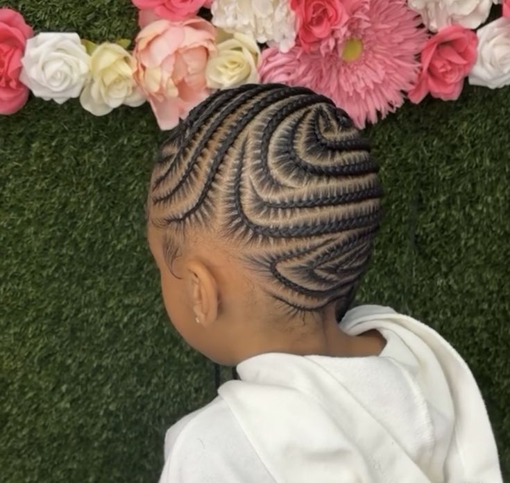 Little girl with a neat part side swept curved ponytail