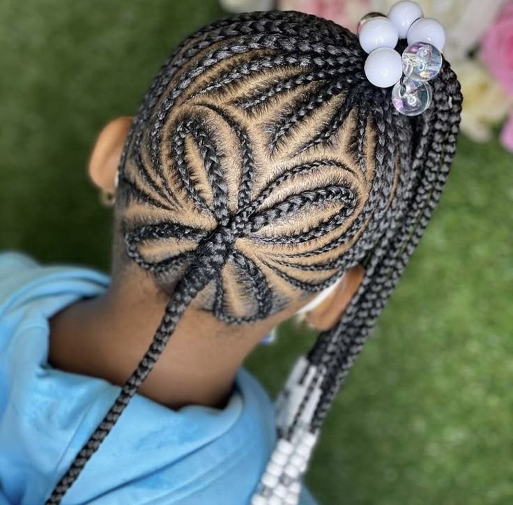 Little girl wearing butterfly part feed in braids with a detailed butterfly design.
