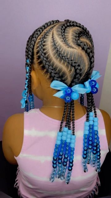 Little girl with a lovely S part feed in braids  with blue hair accessories