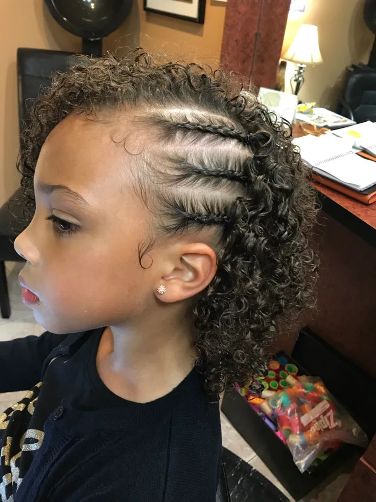 Young  girl with a side swept curl with braids on one side
