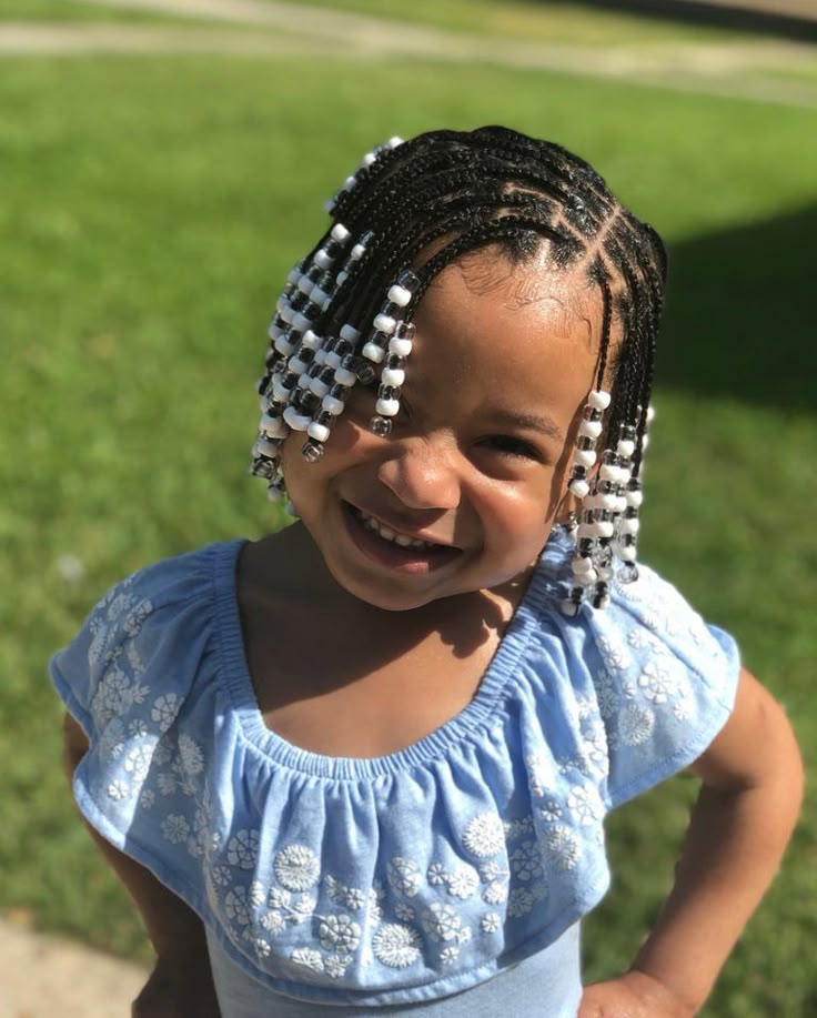 Cute chubby little girl with a beautiful braid decorated with white and clear beaads