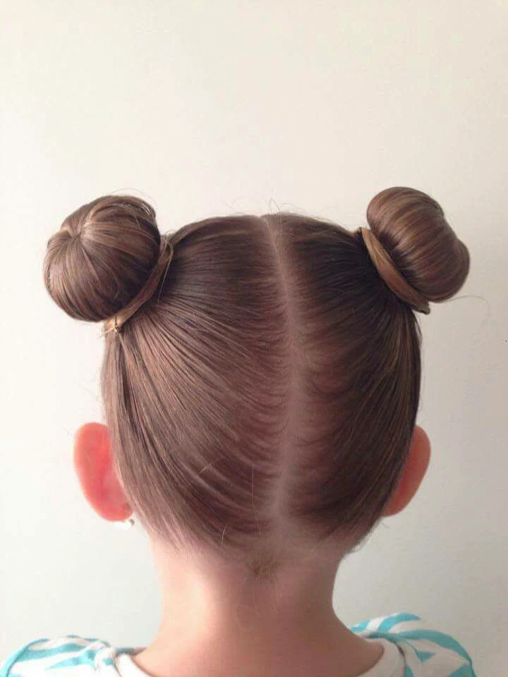 Young girl with a cut double space bun.