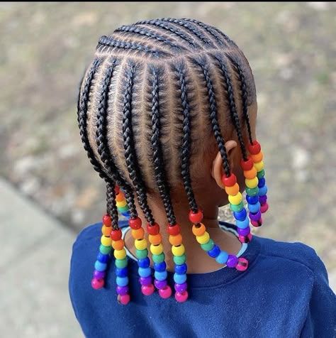 Child with cornrows finished with colorful rainbow beads