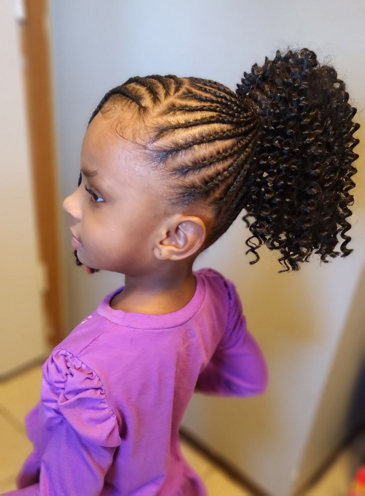 Cute young girl with a half cornrow half curl hairstyle 