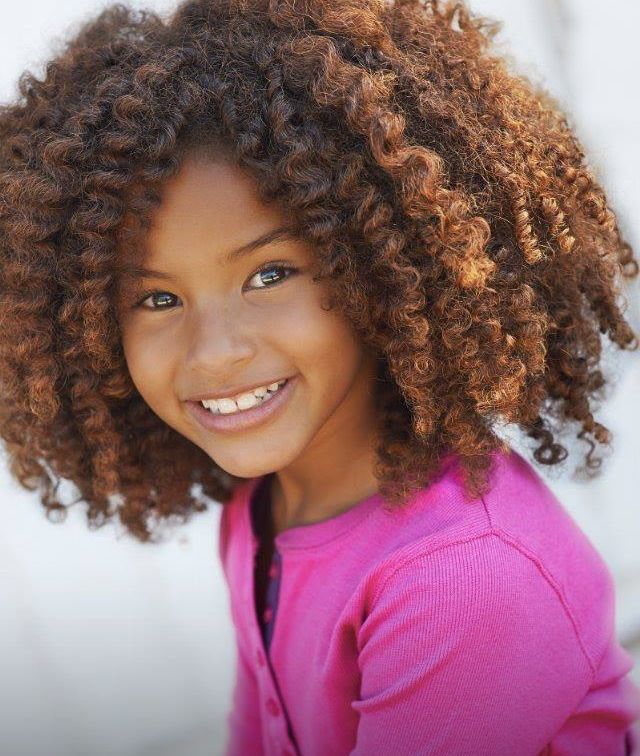 Cute young girl with a full fluffy twist out