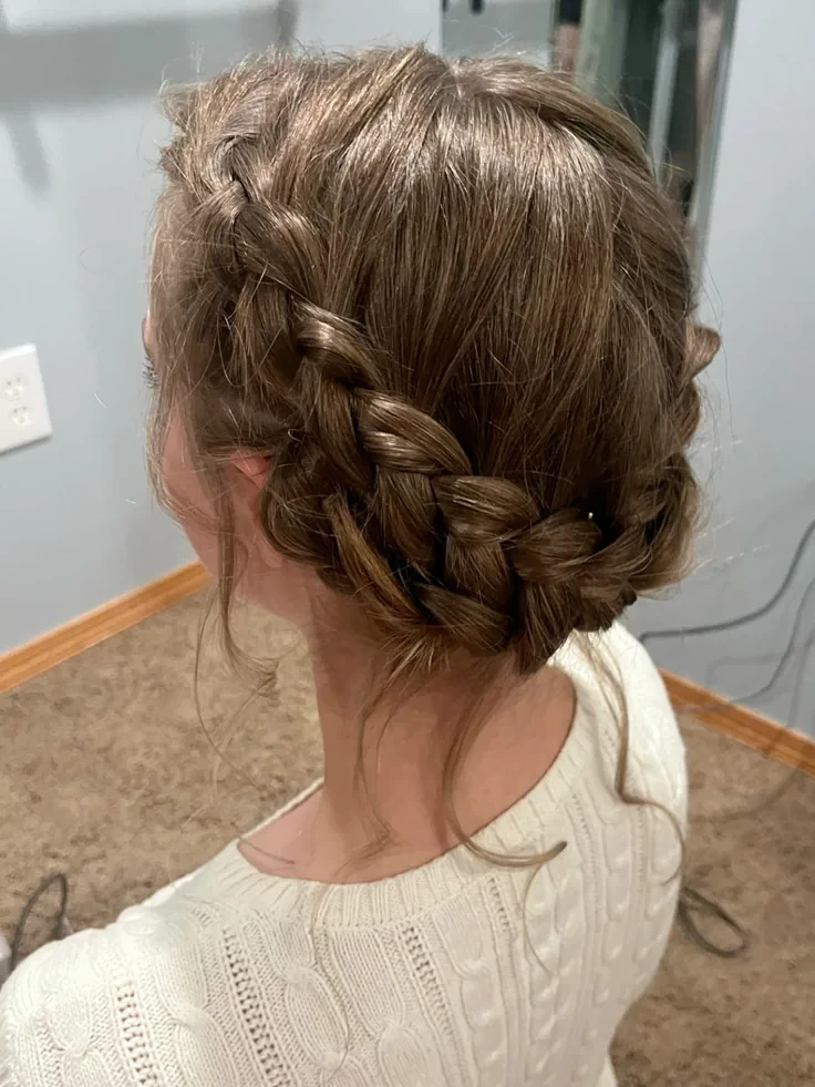 Young girl with a messy braided crown.