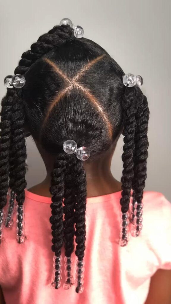 Young girl with a two strand beaded twist pigtail