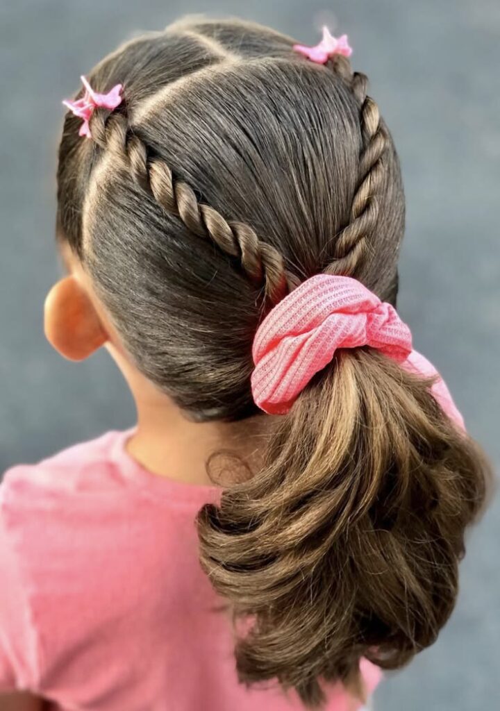 Girl with front twists framing the face while the rest of the hair stays loose