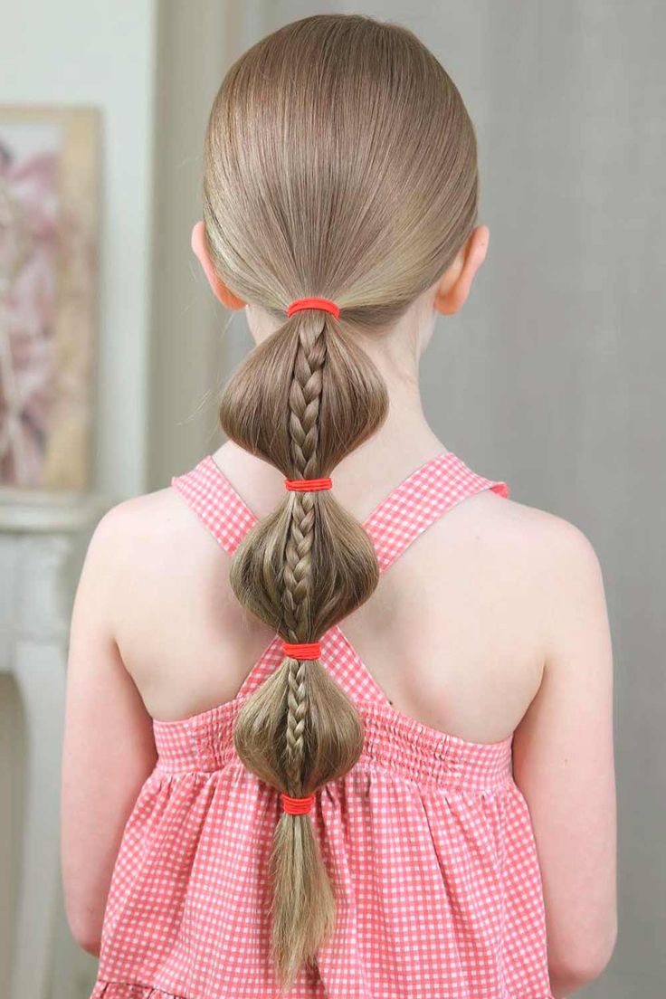 Child wearing a bubble ponytail with braided detail sectioned into rounded bubbles
