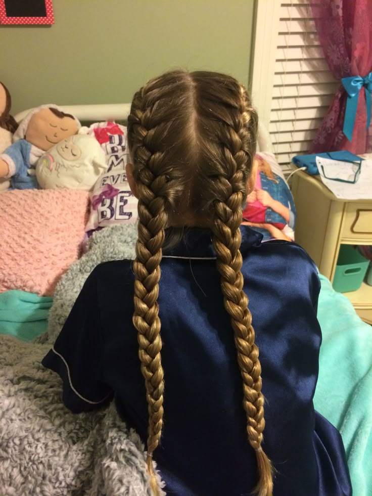 Girl wearing a classic French braid pulled back from the hairline