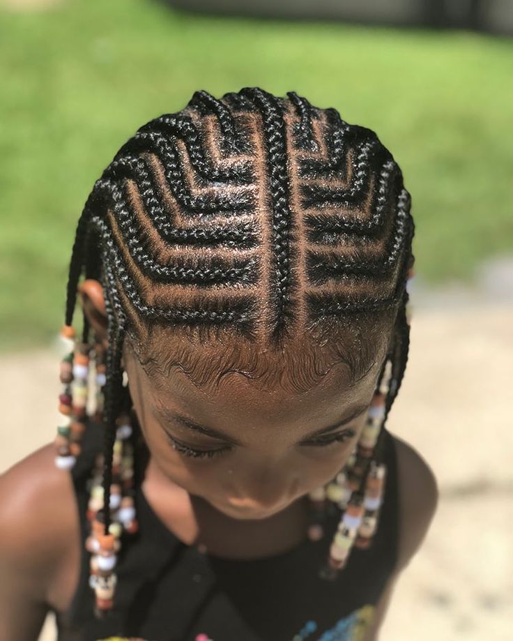 Tribal braids with bold, curved parts creating a geometric pattern