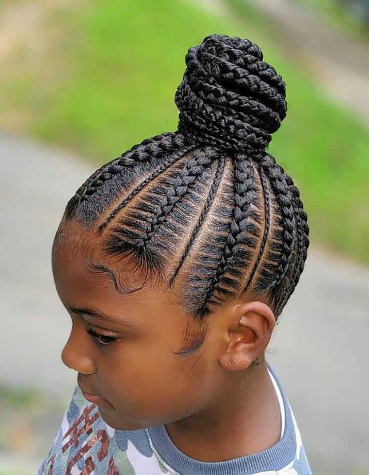 Braids gathered into one neat bun for a polished school look