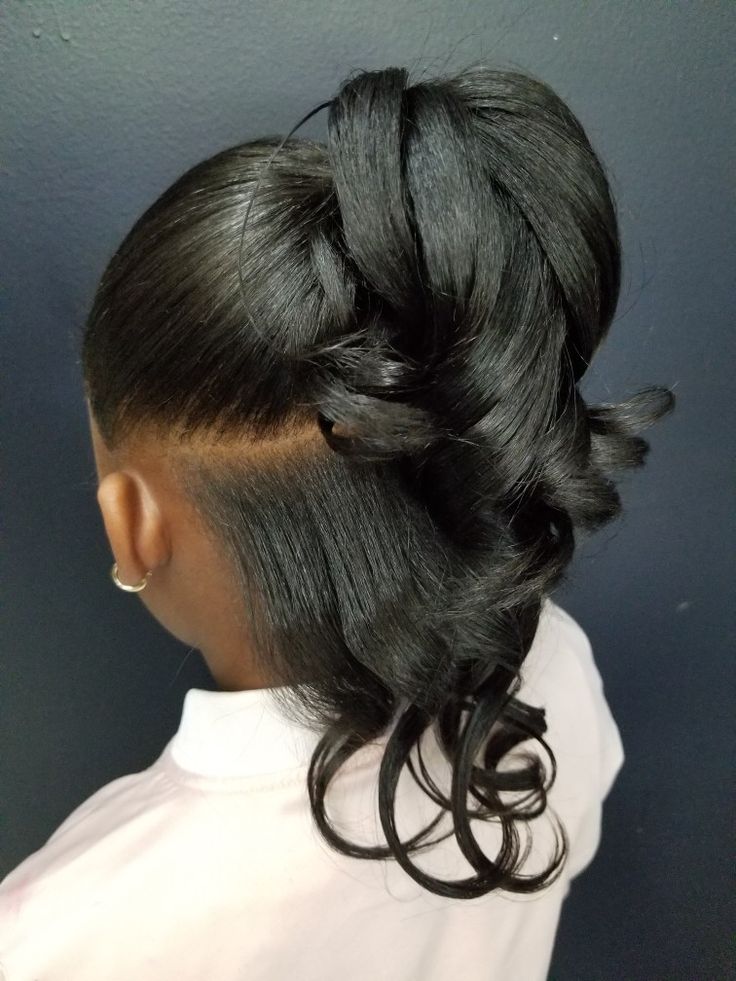 Girl with a half-up ponytail, top section secured and the rest left down for photos