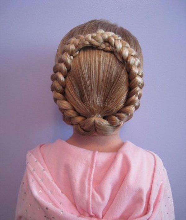 Child wearing milkmaid braids crossed over the top of the head like a crown