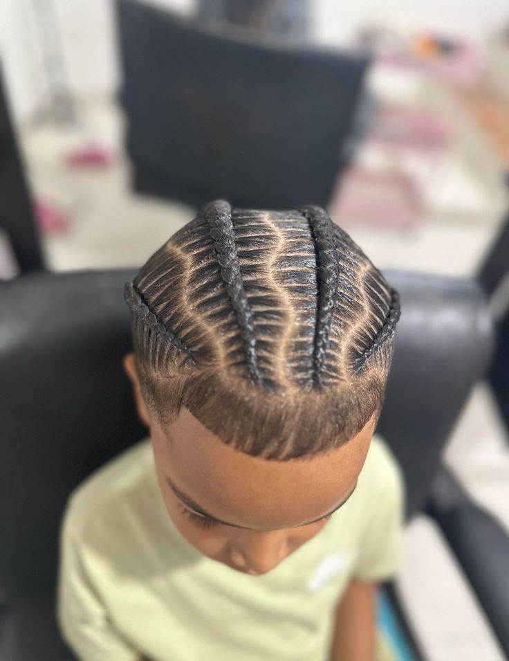 Overhead close-up of a young boy with stitch braids
