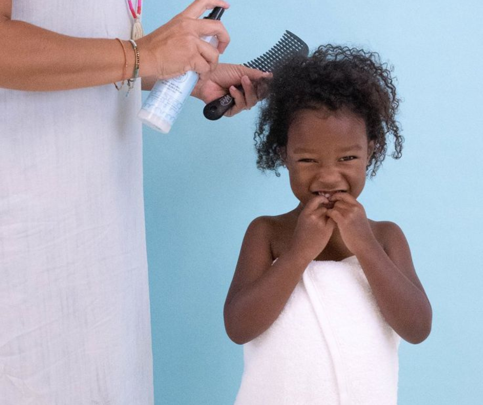 child laughing during hair detangling routine