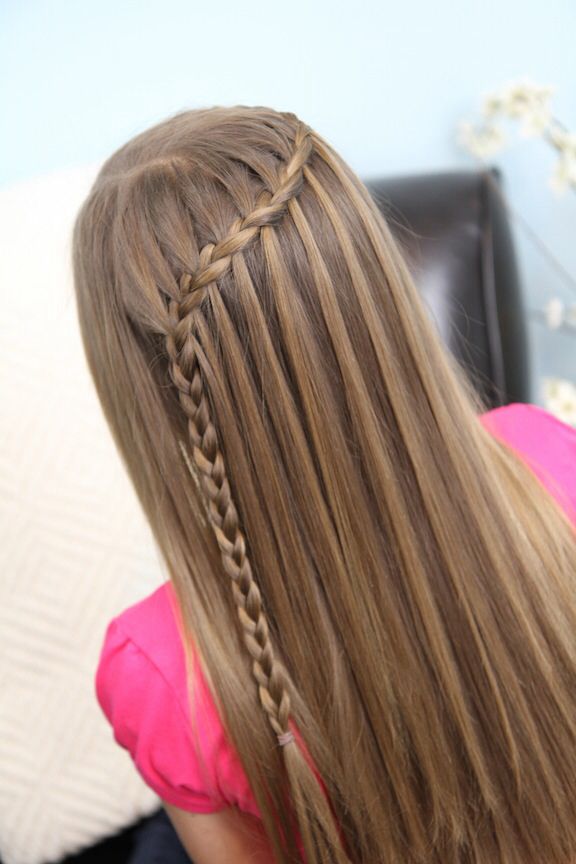 Girl wearing a waterfall braid with hair  sections cascading loose along the braid