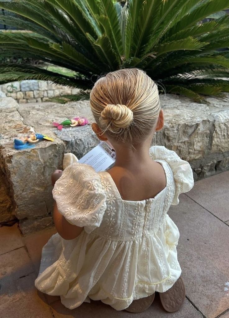 Girl with a neat low bun secured near the base of the neck