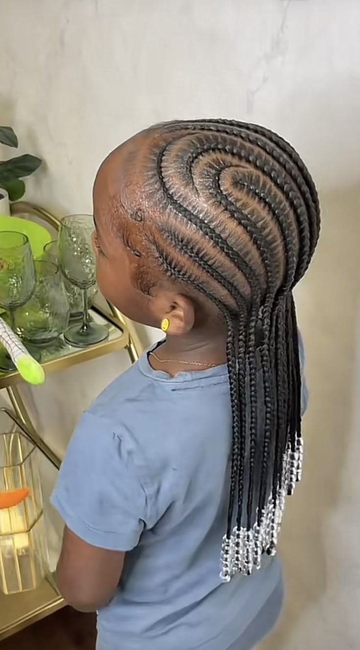 Curved cornrows following soft, sweeping lines across the scalp