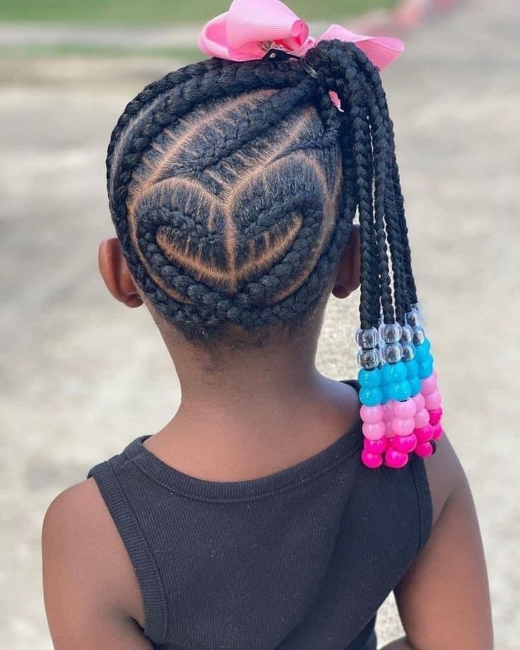 Cornrows parted into a heart design at the back  of the head