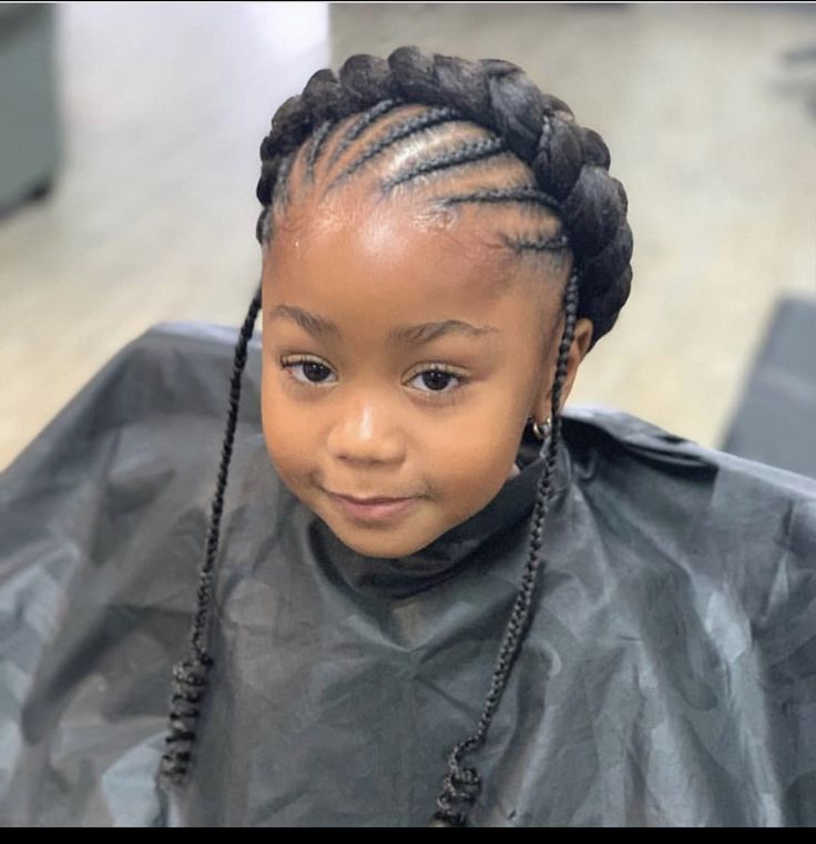 Thin cornrows feeding into one thick braid wrapped around the head like a crown