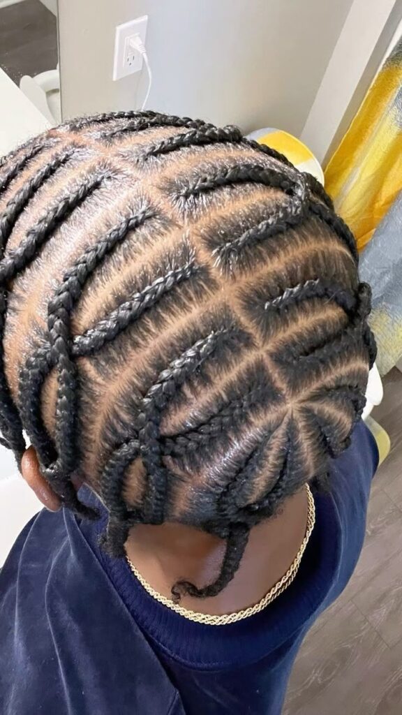 Boy with cross-over cornrows hairstyle