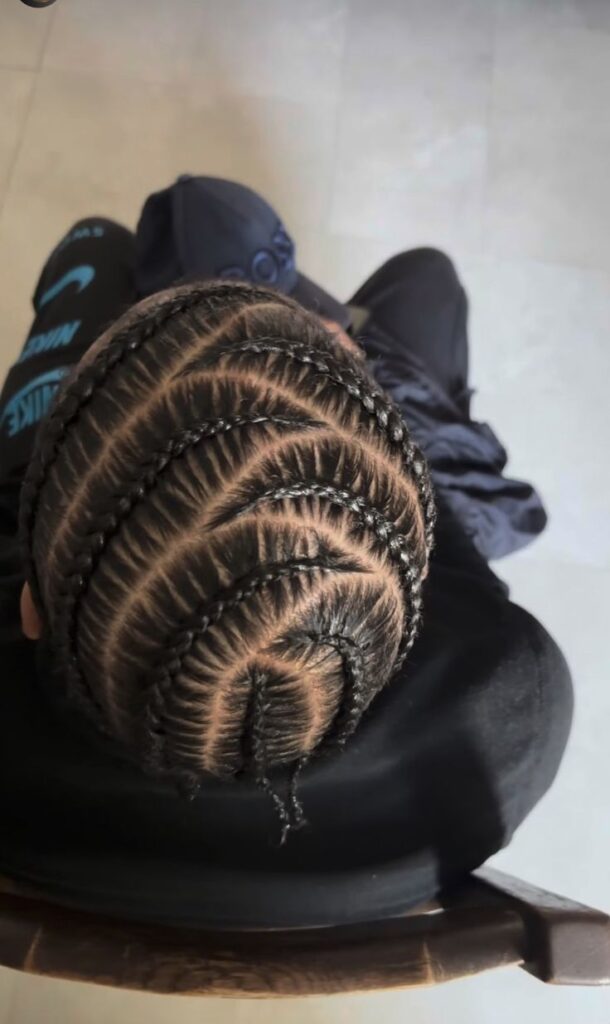 Boy with curved stitch braids hairstyle