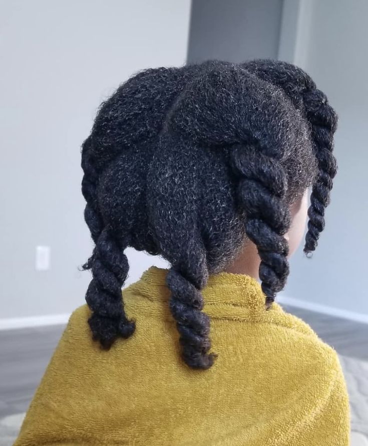 Close-up of a child's hair sectioned into large twisted parts."