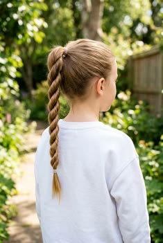 Child with a rope braid ponytail, outdoors