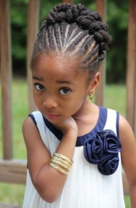 Child with a neat braided updo, hair pulled back into cornrows.