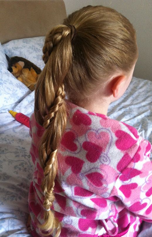 Girl with a high ponytail wrapped with small braided strands.