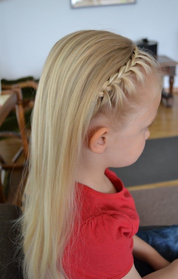 A blond child with braided headband