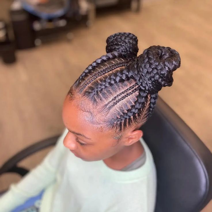 Girl with a neatly styled braided double bun hairstyle