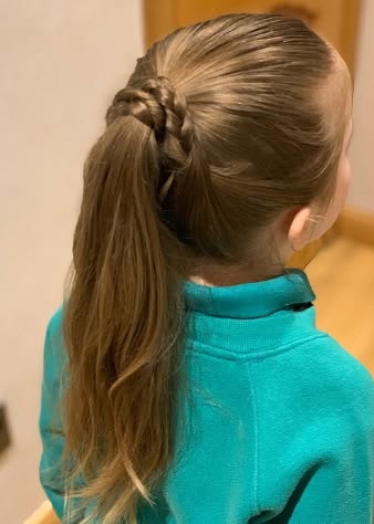 Girl with a ponytail wrapped at the base with a braid