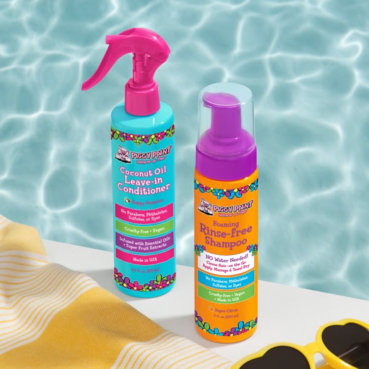 Coconut oil leave-in conditioner and rinse-free shampoo bottles by a pool