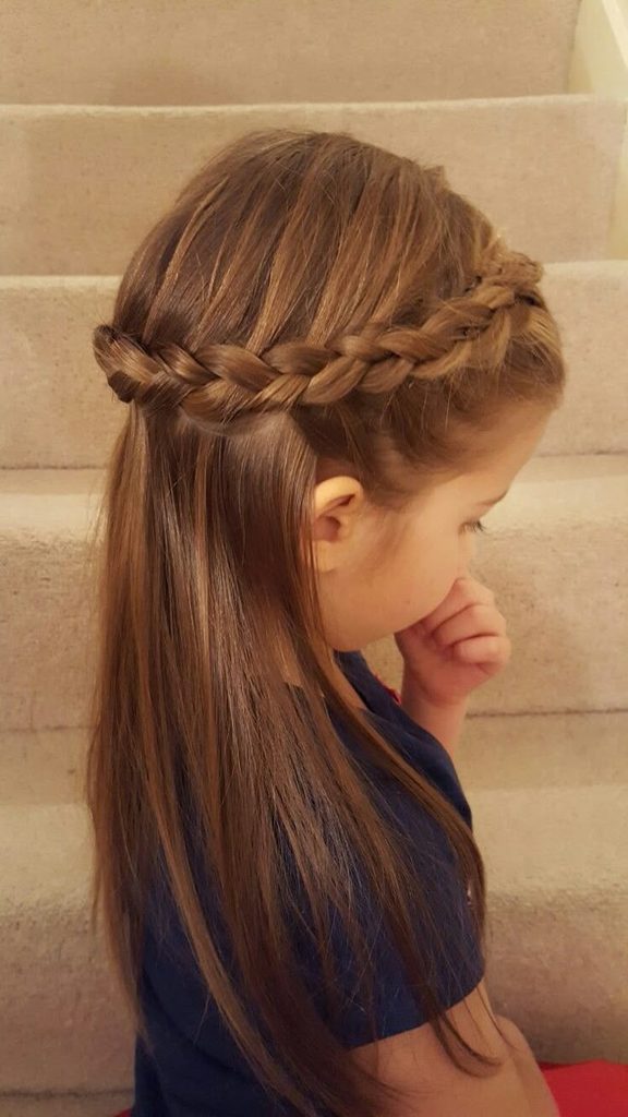 Young girl with a half-up braided crown hairstyle, long straight hair falling past her shoulders