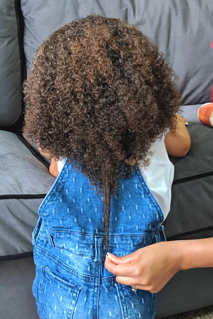 Back view of a child's shiny, defined curly hair