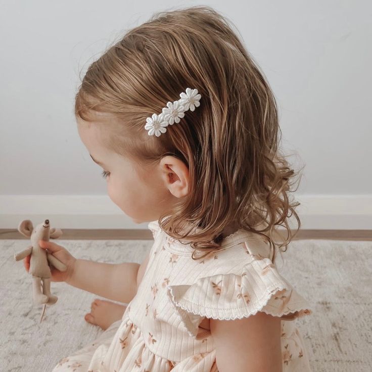 Toddler with a small flower clip on the side of her hair