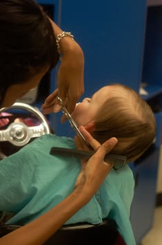 Toddler getting their first haircut in a salon chair