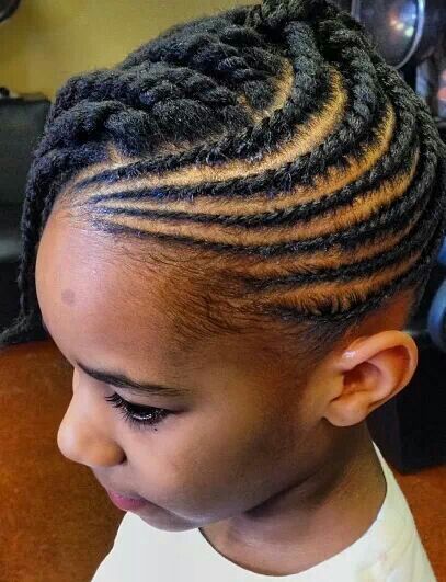 Little girl with flat twists styled in a swirled pattern along the scalp