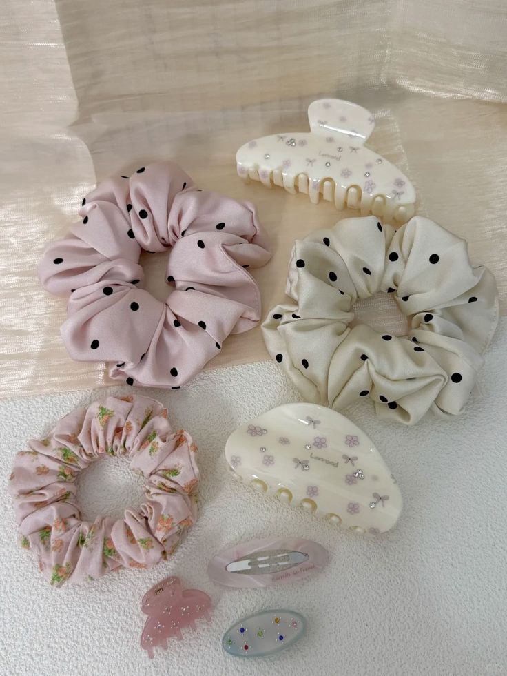 Fabric scrunchies and plastic claw clips in pink and floral patterns