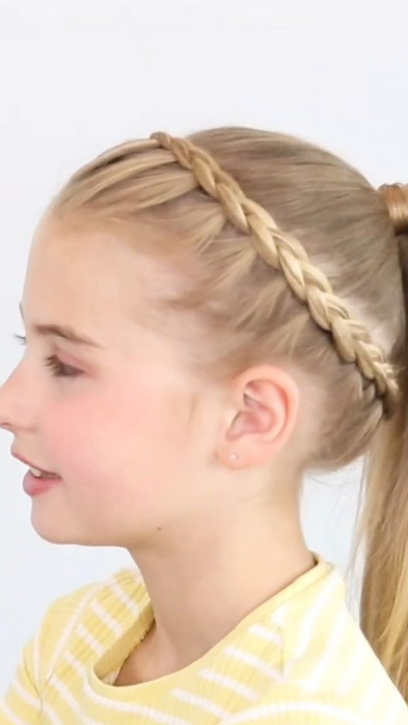 Girl with a braided headband leading into a ponytail