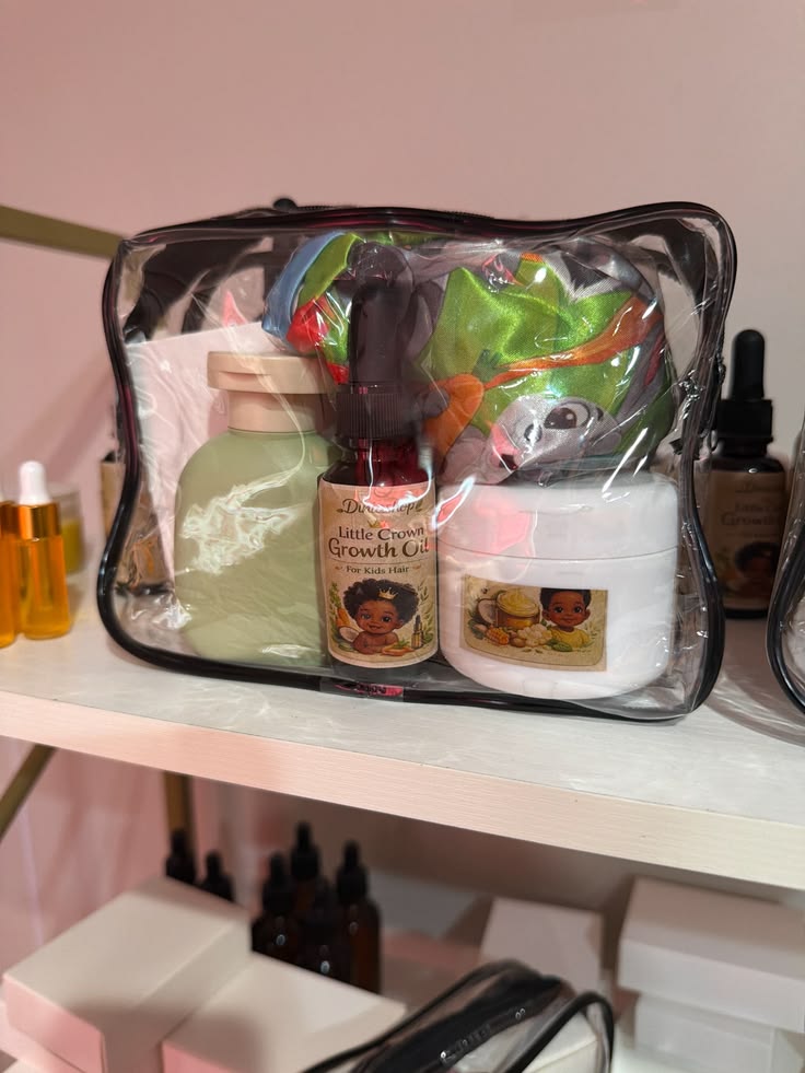 Clear travel bag packed with kids hair care products, including growth oil and moisturizing cream