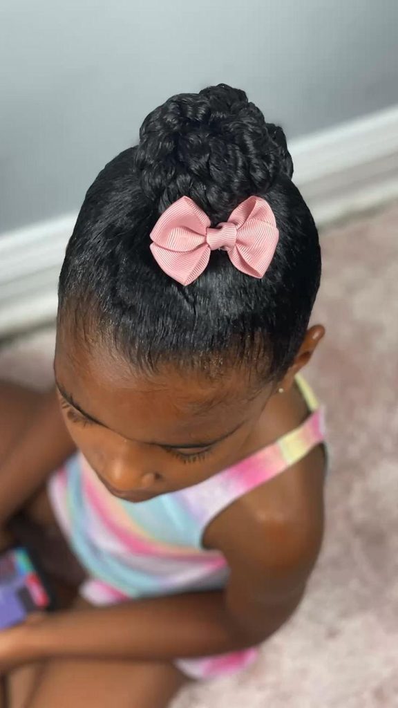 Child with a twisted bun and pink bow