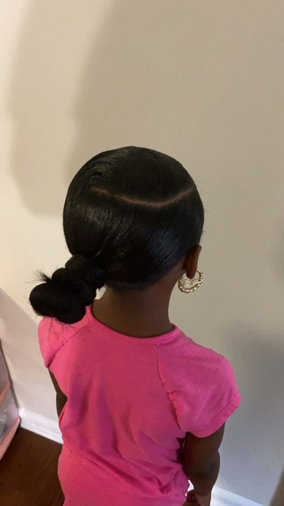 Young girl with a sleek low ponytail